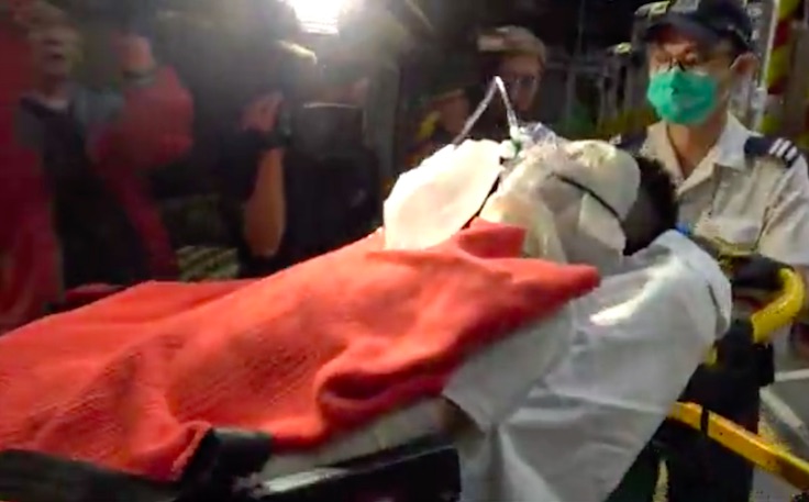 A student being taken into hospital after a suspected dust explosion in a student dormitory at Hong Kong Baptist University. Screengrab via Apple Daily video.