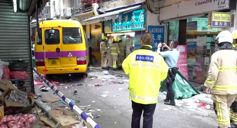 Emergency services investigate the scene of a traffic accident in North Point that killed two people. Screengrab via Apple Daily video.