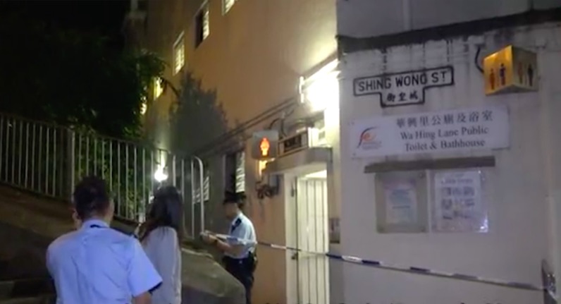 Police officers cordon off the public toilet where two of the thieves went to hide after stealing some jade and cash from an elderly man. Screengrab via Apple Daily video.