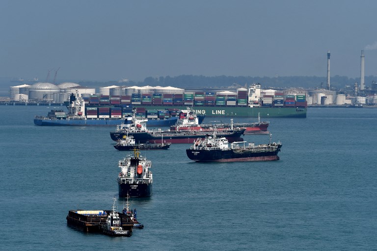 This photograph taken on June 6, 2018 shows vessels anchored along the southern strait of Singapore. (Photo by Roslan RAHMAN / AFP)