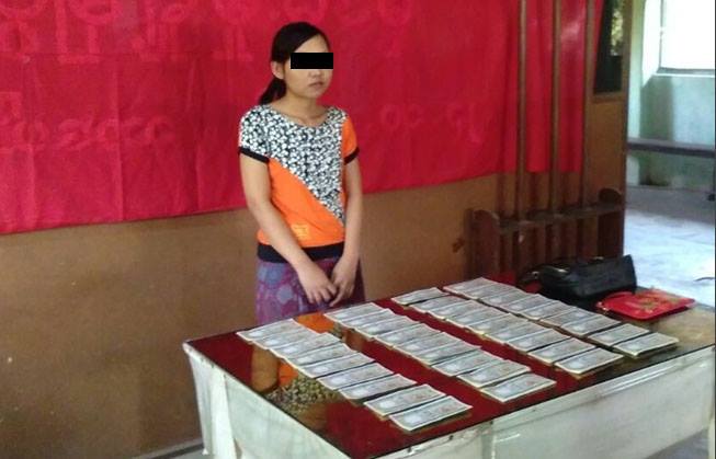 Naw Taw Twe Htoo, a domestic worker employed in Singapore since 2017 – photographed in front of counterfeit bills that are being presented as evidence. Rights groups, workers unions and her family are calling for her immediate release following inconsistencies in the police’s case. 
