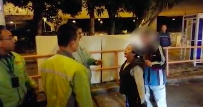 A 60-year-old man surnamed Lam (wearing a black jacket) was arrested for attacking a bus driver after it startled him. Screengrab via Apple Daily video.