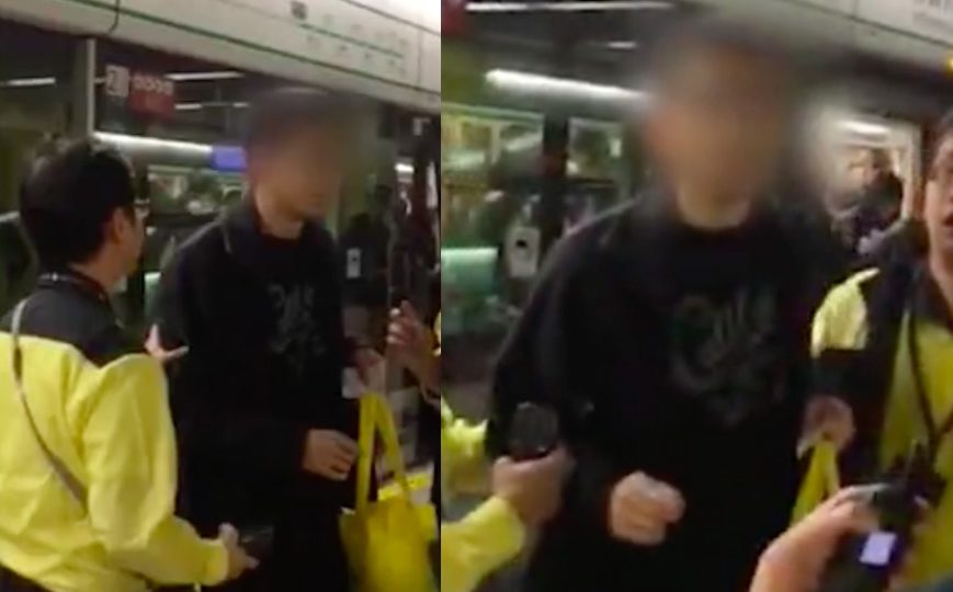 MTR staff apprehend a man who was caught following a woman around Wong Tai Sin MTR station and masturbating next to her. Screengrab via Apple Daily video.