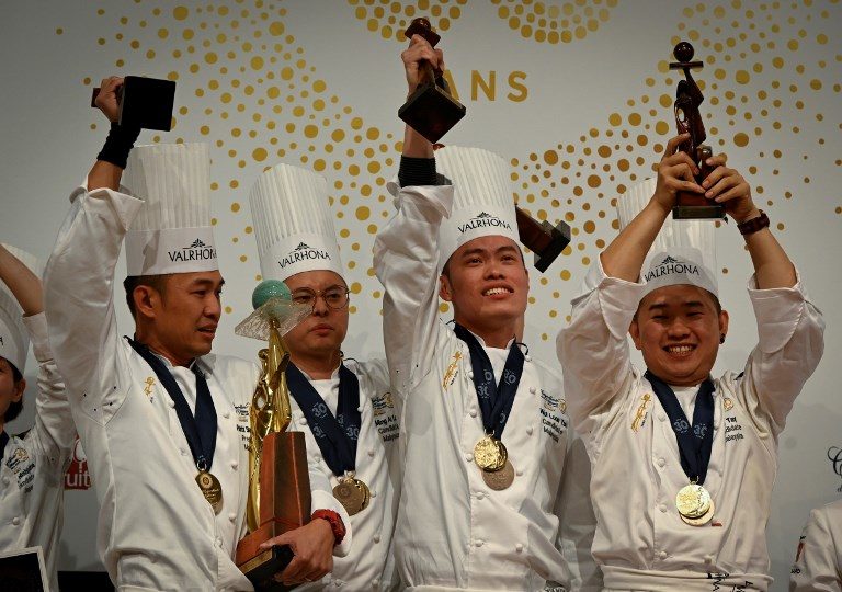 Members of the Malaysia team (LtoR) Situ Chi Yin, Ming Ai Lol, Wei Loon Tan and Otto Tay celebrate with their trophy after winning the Pastries World Cup final on January 28, 2019 in Chassieu, outside Lyon, as part of the Catering and Food International Show (SIRHA). (Photo by JEAN-PHILIPPE KSIAZEK / AFP)