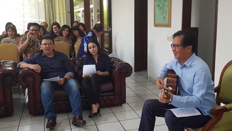 BTP is shown sitting next to his rumored fiancé, a former police officer named Puput Nastiti Devi. Photo: Tim BTP