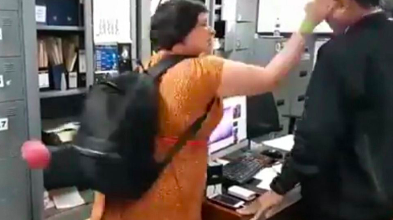 Auj-e Taqaddas pictured slapping an Immigration officer in Bali in July 2018. Image from viral footage via @lambe_turah