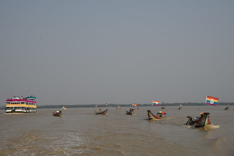 The main boat (left) is surrounded by other small boats with pride flags adorned on them (Photo: Thet Htoo / &PROUD)