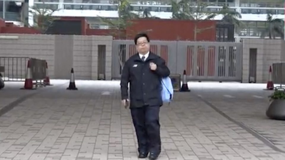 Howard Lam standing outside West Kowloon Courts. He’s on trial accused of knowingly filing a fake police report after claiming he was kidnapped and tortured by mainland agents. Screengrab via Apple Daily video.