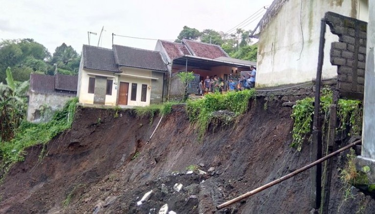 A Tabanan house tumbled into the river below after Monday’s heavy rains caused a mudslide. Photo: Facebook/N A K B A L I