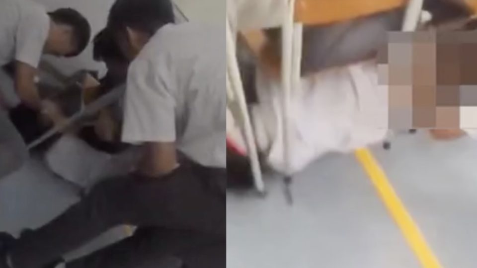 Eight teenage boys have been arrested after a video of them harassing another boy by pinning him down and pulling down his pants went viral. Screengrabs via Apple Daily video.