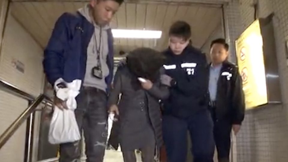 41-year-old Ming Yongfang being arrested after stabbing her husband’s mistress. She was sentenced to two years in jail at the District Court on January 30. Screengrab via Apple Daily video.