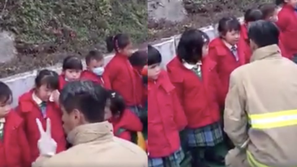 A fireman won the hearts of netizens after he was filmed comforting a group of kindergarten kids who got caught up in a school bus crash last week. Screengrab via Facebook/Esther Chan.