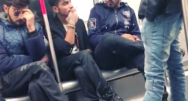 A man was caught on camera smoking inside a train on the MTR. Screengrab via Apple Daily.