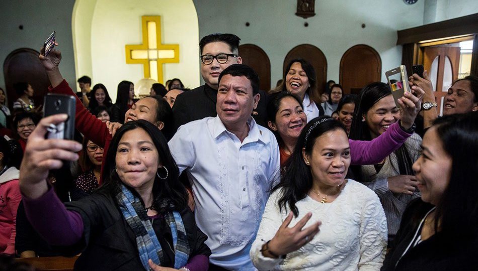 An impersonator of Philippine President Rodrigo Duterte (center front), who goes by the name Cresencio Extreme, and a North Korean leader Kim Jong Un impersonator (behind), who goes by the name Howard X, pose for photos as they attend a church service in the Central district of Hong Kong. Photo: Isaac Lawrence, AFP