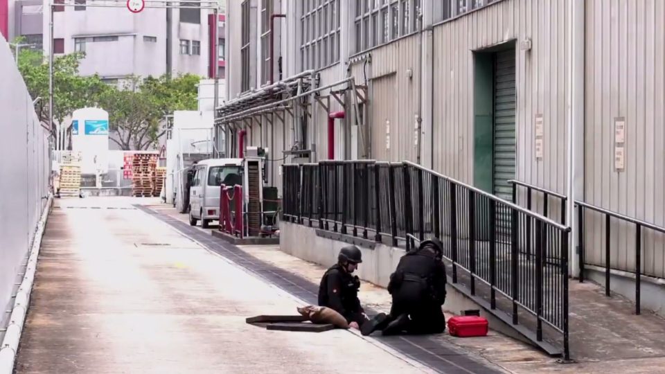Bomb disposal officers prepare to detonate an unexploded WWI-era German grenade that was found in a shipment of French potatoes in Hong Kong on Saturday. Screengrab via Twitter.