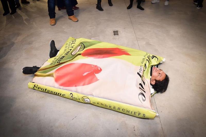 Artist Rizman Putra unveiled his latest creation in a Paris exhibition featuring Singapore artists: a performance piece of himself as a tissue packet. (Photo: Singapore Embassy in Paris / Facebook)