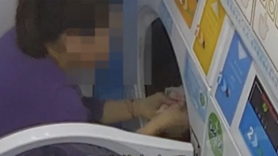 A woman has been caught on CCTV stealing about HK$70,000 from a washing machine. Screengrab via Apple Daily video.