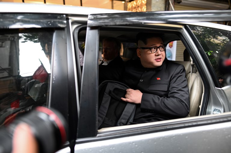 Kim Jong Un impersonator Howard X is escorted by Vietnamese authorities to the airport for deportation in Hanoi yesterday. Photo via AFP.
