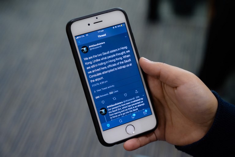 The @HKsisters6 Twitter account feed of Rawan and Reem displayed on Reem's phone during a recent interview. Photo via AFP.