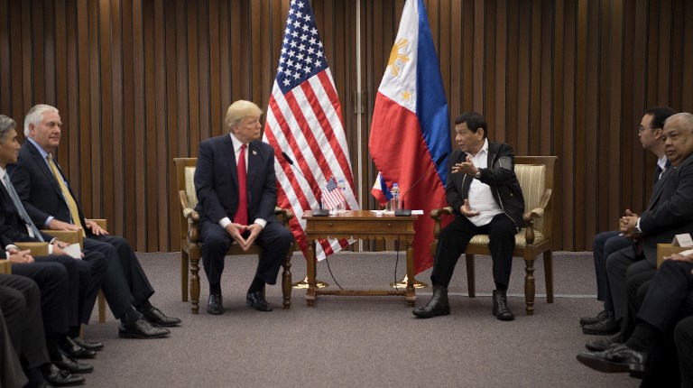 US President Donald Trump (L) listens to Philippine President Rodrigo Duterte during their bilateral meetin on the side line of the 31st Association of South East Asian Nations (ASEAN) Summit in Manila on November 13, 2017. – World leaders are in the Philippines’ capital for two days of summits. (Photo by JIM WATSON / AFP)