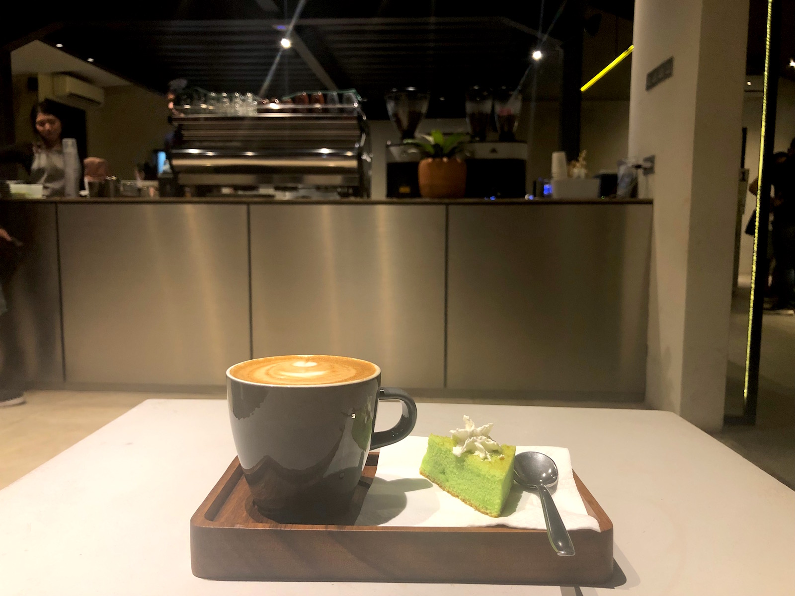 Cappuccino and pandan cake at Kopi Kalyan's newest branch in Barito area. Photo: Nadia Vetta Hamid/Coconuts Media