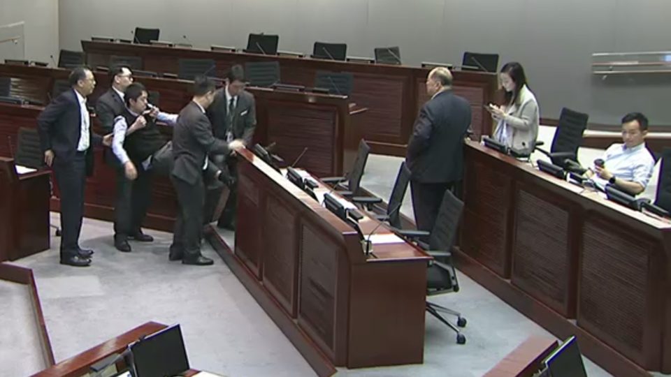 Lawmaker Ted Hui Chi-fung is carried out of a LegCo meeting earlier today. Screengrab via LegCo.