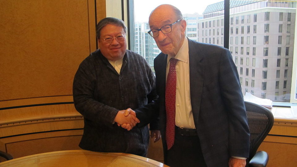 Former Hong Kong Home Affairs Secretary Patrick Ho (left) shakes hands with former US Federal Reserve Chairman Alan Greenspan in 2015. Ho was sentenced to three years in prison in a US court over a bribery scheme on Monday. Photo via Wiki Commons/Sunrest.