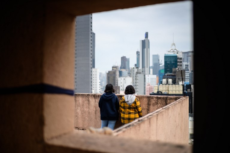 Saudi sisters Reem (left), 20, and Rawan, 18, stand next to each other during an interview in Hong Kong in February. Photo via AFP.