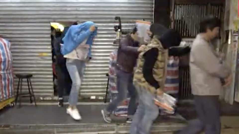 Police bust an arcade gaming center in Sham Shui Po, one of 44 locations to be raided by undercover cops against an operation into illegal gambling. screegrab via Apple Daily video. 