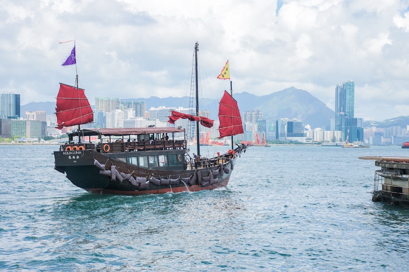 A Chinese merchant ship sails past Avenue of Stars in Hong Kong. (Photo: Unknown Wong / Unsplash)