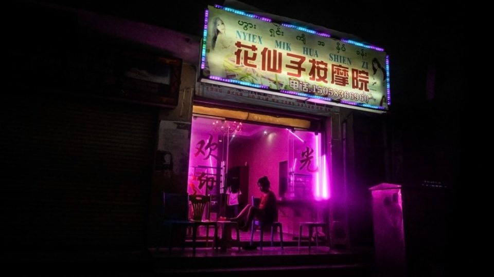 This picture taken on April 17, 2019 shows Chinese characters on a signboard of a shop offering services to cross-border individuals in Panghsang. – Bentleys and BMW convertibles roll up to the brash “Venetian Casino” in Mongla on the Myanmar-China border, a melting pot of sex, drugs and gambling on a frontier that has become a “supermarket” for illegally traded wildlife. As night descends on the quiet streets of Panghsang, pockets of pink light illuminate the gloom – emitted from the countless Chinese-branded massage parlours dotting the roads. (Photo by Ye Aung THU / AFP)