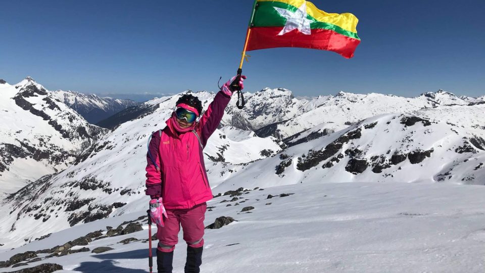 Saint Htet, 28, posing with the Myanmar Flag on Phangran Razi in Kachin State via Zaw Khine’s Facebook page.