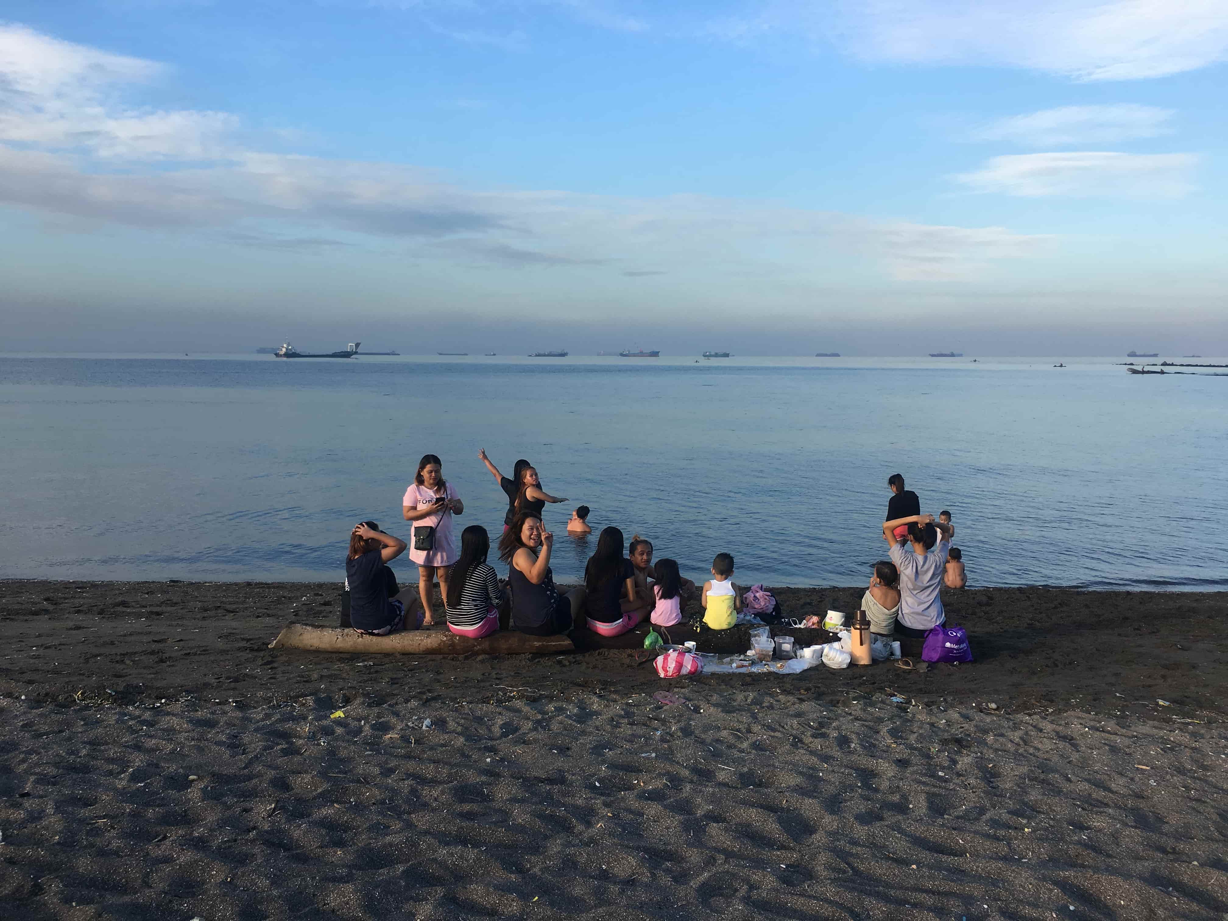 Sunday beachgoers. (Photo: Therese Reyes/Coconuts)