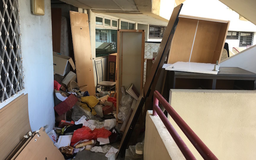 Rubbish tossed by residents blocks a passage at Singapore’s Pearl Bank Apartments, scheduled for demolition in coming weeks. Photo by Robin Hicks