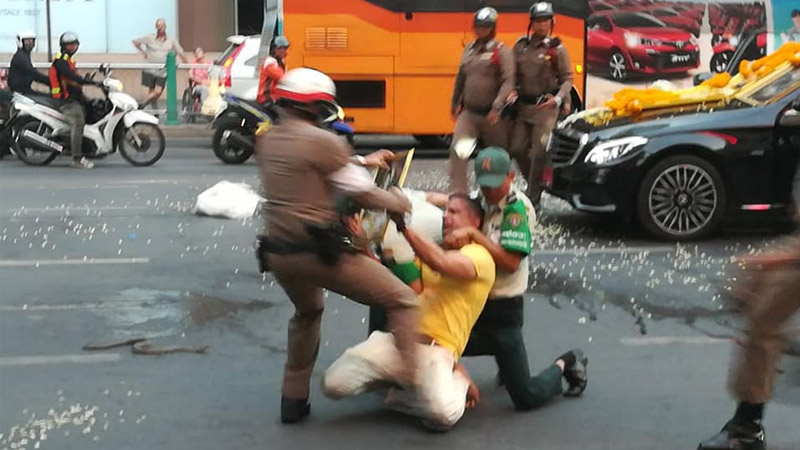 Police wrestle with a man who set loose two cobras and waved around a large knife Wednesday night outside Bangkok’s CentralWorld shopping mall. Photo: 
Guiitam Gittimas/Facebook