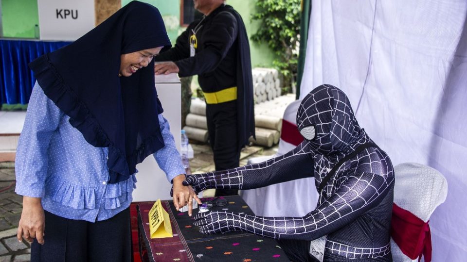 Indonesian election workers dressed in superhero costumes register voters at a polling station in Surabaya on April 17, 2019. Juni Kriswanto / AFP