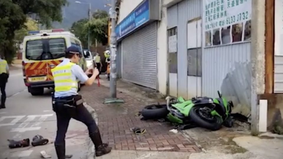Police at the site of a motorcycle crash. Screengrab via Apple Daily video.