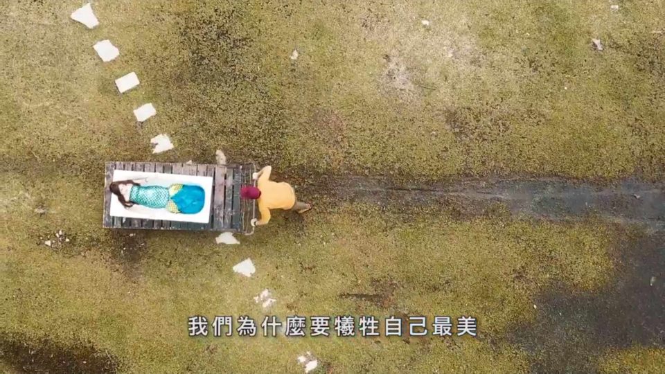 An eco-conscious young man wheels a mermaid, played by Hong Kong actress Lana Wong Ha-wai, across Lantau in a new video from Greenpeace. Screengrab via Greenpeace.