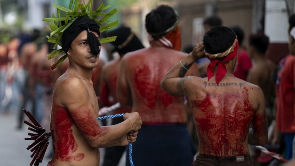 Christian devotees whip their backs with bamboo strips on a street in San Juan, Pampanga on April 19, 2019, during the reenactment of the crucifixion of Jesus Christ on Good Friday. Noel Celis / AFP