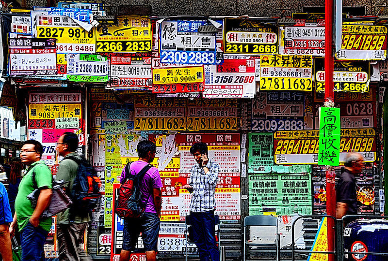 A Hong Kong real estate agency plastered with advertisements. Photo via Flickr/Luca Bolatti Guzzo.
