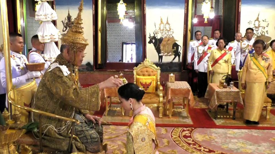 This screengrab from Thai TV Pool video taken on May 4, 2019 shows Thailand’s Princess Sirindhorn (R) watch as Queen Suthida kneels in front of King Maha Vajiralongkorn (L) during his coronation in Bangkok. (Photo by Thai TV Pool / THAI TV POOL / AFP)