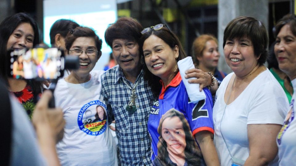 This photo taken on April 30, 2019 shows Gertrudes Batocabe (C), wife of the late congressman Rodel Batocabe, posing for photos with supporters during a campaign rally in the town of Daraga, Albay province, south of Manila. – Batocabe never wanted to enter the Philippines’ cutthroat politics, but after her husband was shot dead, allegedly by a rival in midterm elections taking place on May 13, she felt bound to take his place. (Photo by STR / AFP)