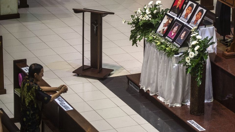 A man attends a memorial service at Santa Maria Catholic Church in Surabaya on May 13, 2019, to remember the victims of suicide bombings carried out by an Islamic State-inspired family. – On May 13, 2018, a family of six — including two girls aged nine and 12 — blew themselves up at the Santa Maria Catholic Church and two other churches in Surabaya during Sunday morning services, killing over a dozen congregants and wounding scores more. (Photo by Juni Kriswanto / AFP)