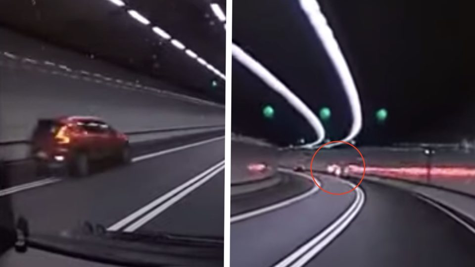 Dash cam video posted online shows the moment a red Volvo crashes into the side of the Central-Wan Chai bypass in Hong Kong. Screengrab via YouTube.