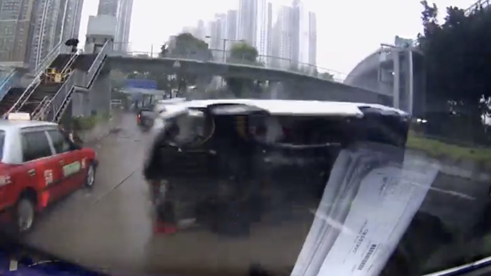 A van was caught on dash cam flipping onto its side on a wet road. Screengrab via Facebook video.