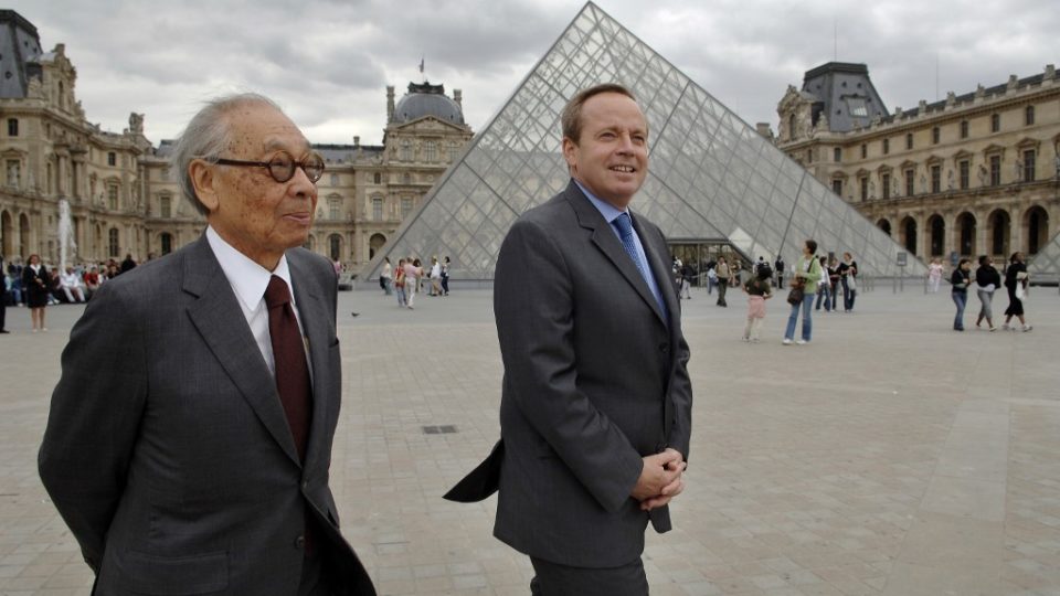 I. M. Pei (left) and French Culture Minister Renaud Donnedieu de Vabres walk past Pei’s iconic pyramid at the Louvre, in Paris. Photo via AFP.