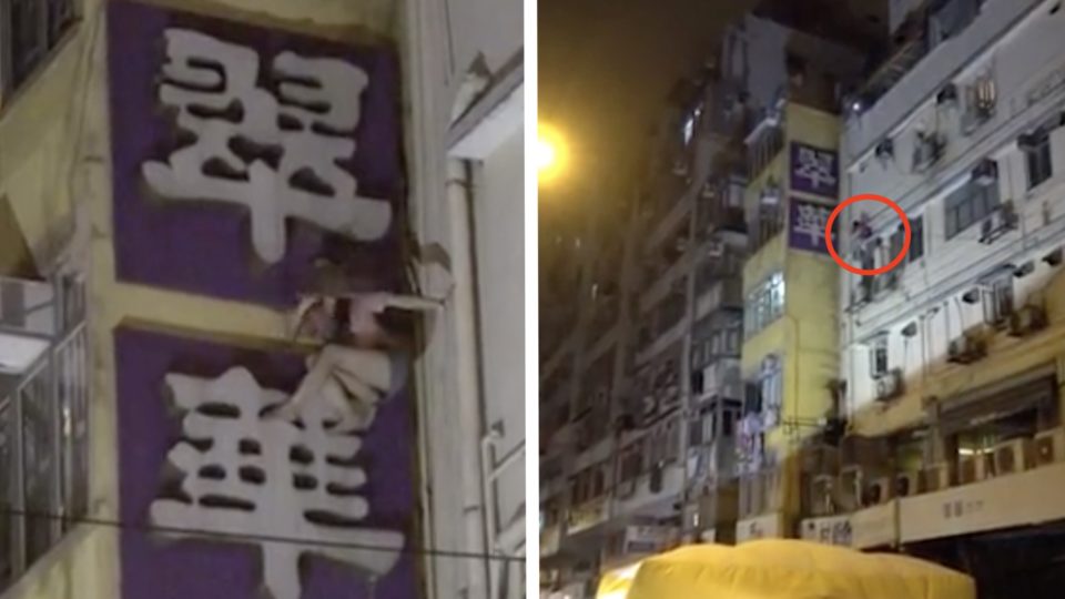 Woman is talked down from jumping off a restaurant sign board in Yau ma Tei. Screengrab via Apple Daily video.