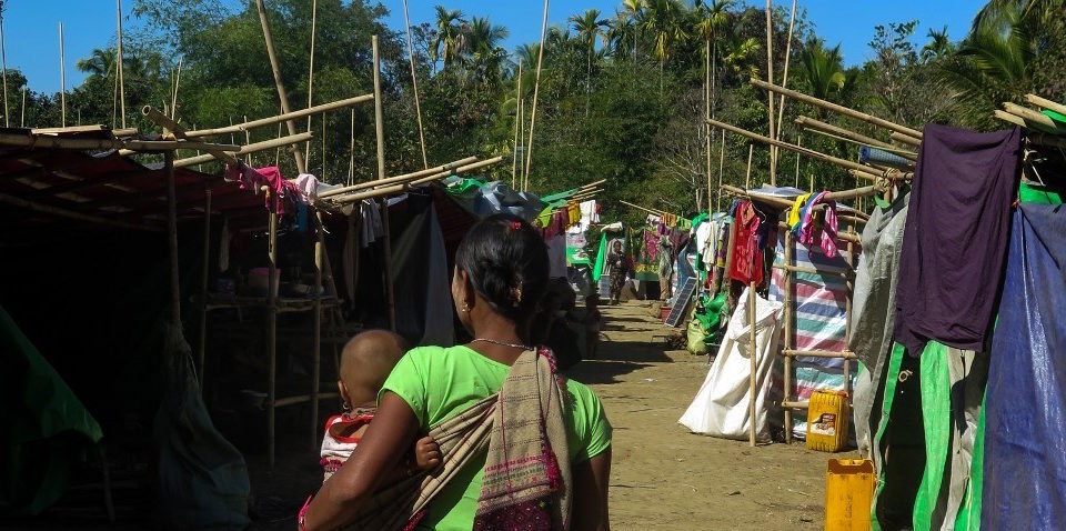 A woman, displaced by violence between ethnic Rakhine rebels and Myanmar’s army, walks with a child at a makeshift camp in Kyauktaw, Rakhine state, on January 5, 2019. – Thirteen Myanmar police officers were killed in raids on January 4 by ethnic Rakhine rebels, the army said, in a brazen, coordinated attack on the country’s Independence Day which adds a dangerous new dimension to conflict in the restive western state. (Photo by – / AFP)