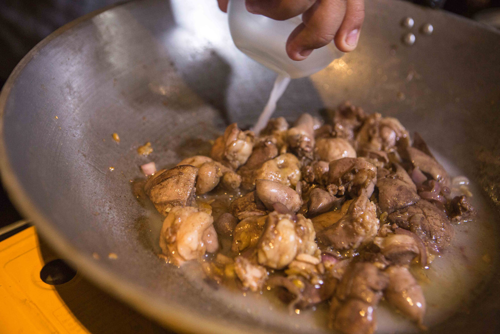 Vinegar added to adobo. (Photo: Jacques Manuntag/Coconuts) 