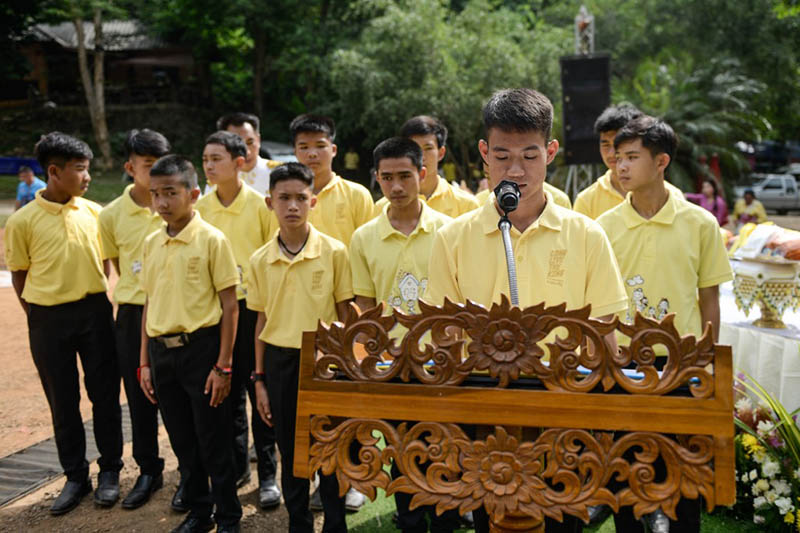 Ekkapol ‘Coach Ek’ Chantawong speaks Monday on behalf of the ‘Wild Boars’ football team as they mark the first anniversary of their rescue from the Luang cave in the Mae Sai district of Chiang Rai province. Photo: Jittrapon Kaicome / AFP